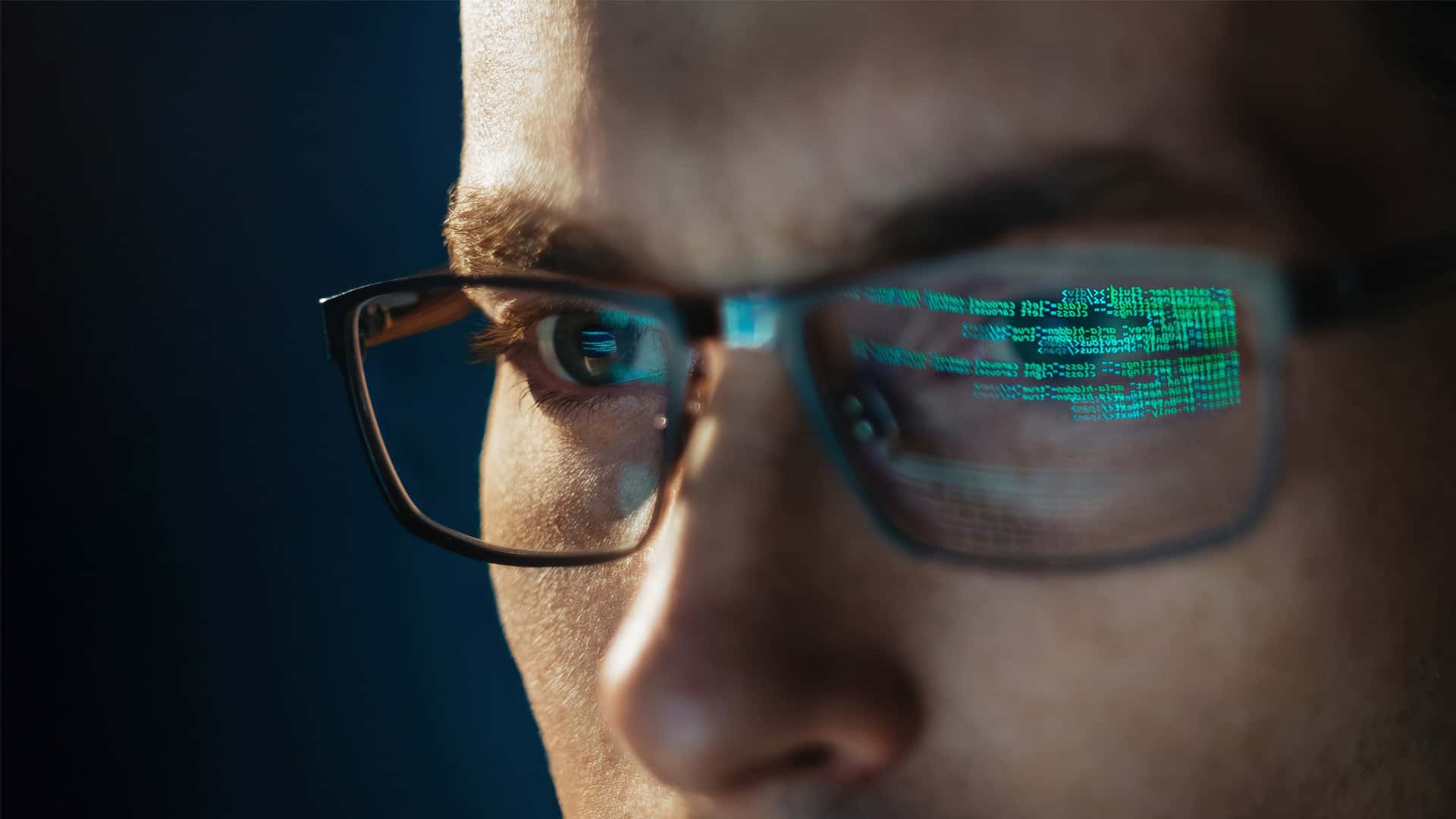 Many reading computer screen reflected in glasses